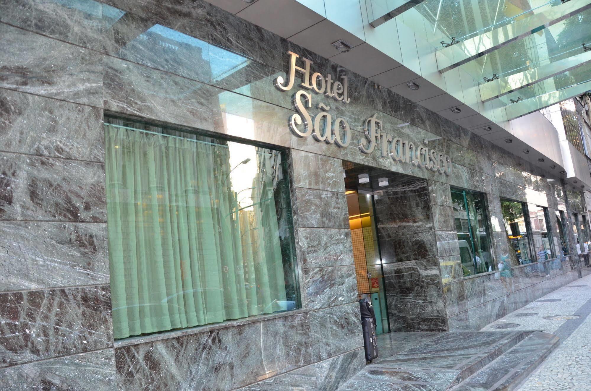 فندق أتلانتيكو تاور ريو دي جانيرو المظهر الخارجي الصورة The photo shows the exterior of a hotel named "Hotel São Francisco." The facade is made of marble, giving it an elegant appearance, and large glass windows are visible, likely allowing natural light to enter the interior. There are light green curtai